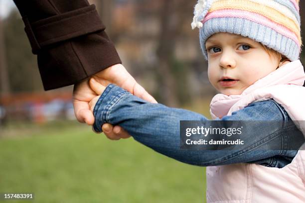 child holding mother's hand - children divorce stock pictures, royalty-free photos & images