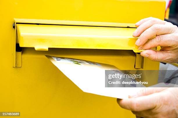 posting letter at mailbox - yellow envelope stock pictures, royalty-free photos & images