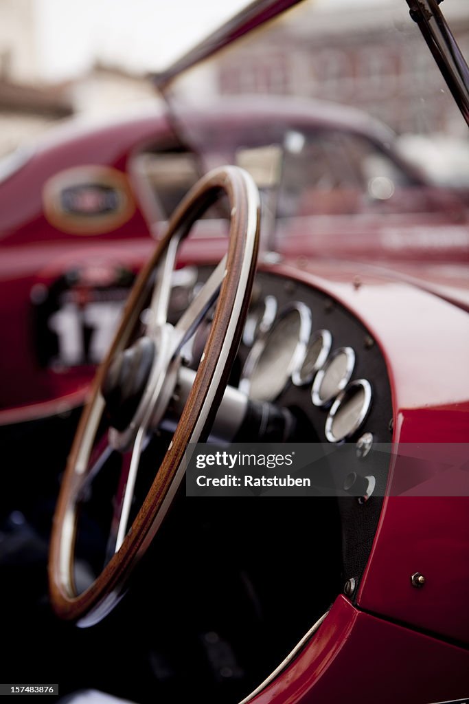 Close up of steering wheel on red classic car