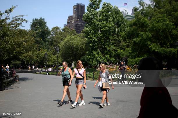 People enjoy a sunny day at Washington Square Park on July 27, 2023 in New York City. According to the National Weather Service, New York City has...