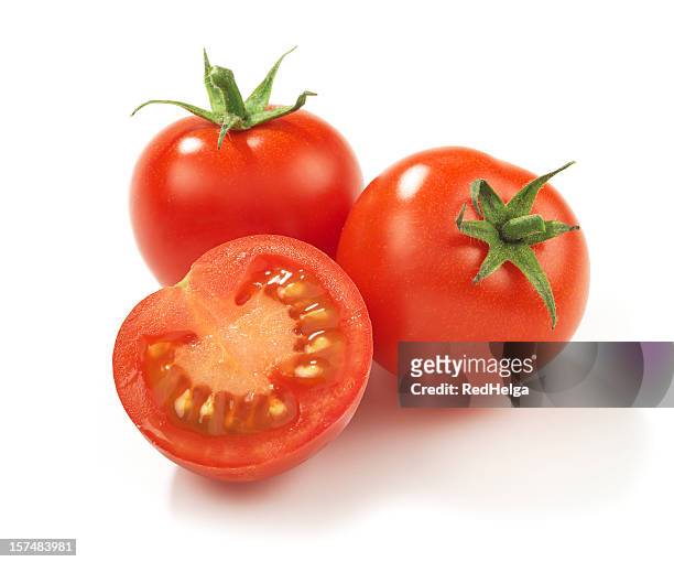 two whole red ripe tomatoes and one in half - tomatoes stock pictures, royalty-free photos & images