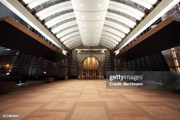 entrance of a skyscraper - building atrium stock pictures, royalty-free photos & images