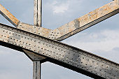 An up close image of the beams holding up a steel bridge
