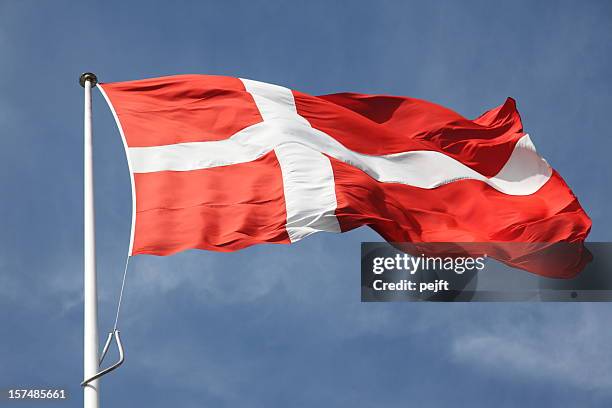 dannebrog the flag of denmark on blue sky - pejft stock pictures, royalty-free photos & images