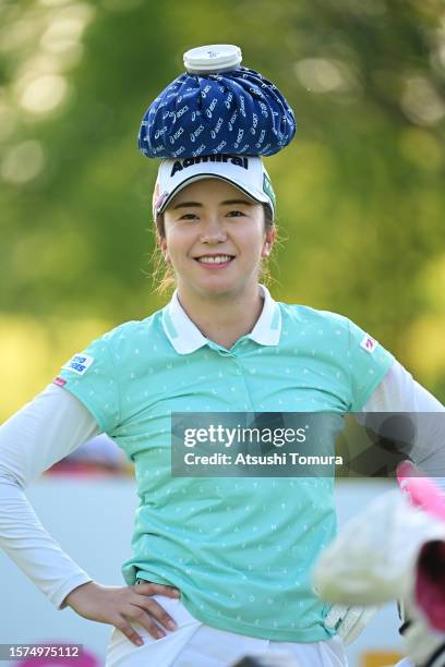 Kotone Hori of Japan puts an ice bag on her head on the 10th hole during the second round of Rakuten Super Ladies at Tokyu Grand Oak Golf Club on...