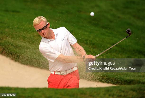 Simon Dyson of England plays a shot during previews ahead of the Thailand Golf Championship at Amata Spring Country Club on December 4, 2012 in...