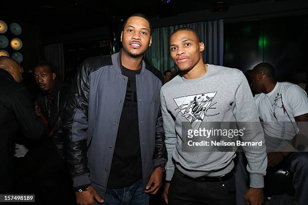Carmelo Anthony and Russell Westbrook attend the Dare To Fly AJXX8 event at PH-D Rooftop Lounge at Dream Downtown on December 3, 2012 in New York...