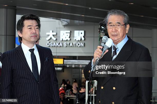 Shintaro Ishihara, former governor of Tokyo and leader of the Japan Restoration Party, right, speaks as Toru Hashimoto, mayor of Osaka and co-leader...