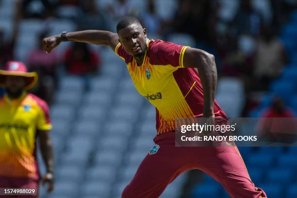 Jason Holder of West Indies celebrates the dismissal of Hardik Pandya of India during the first T20I match between West Indies and India at Brian...