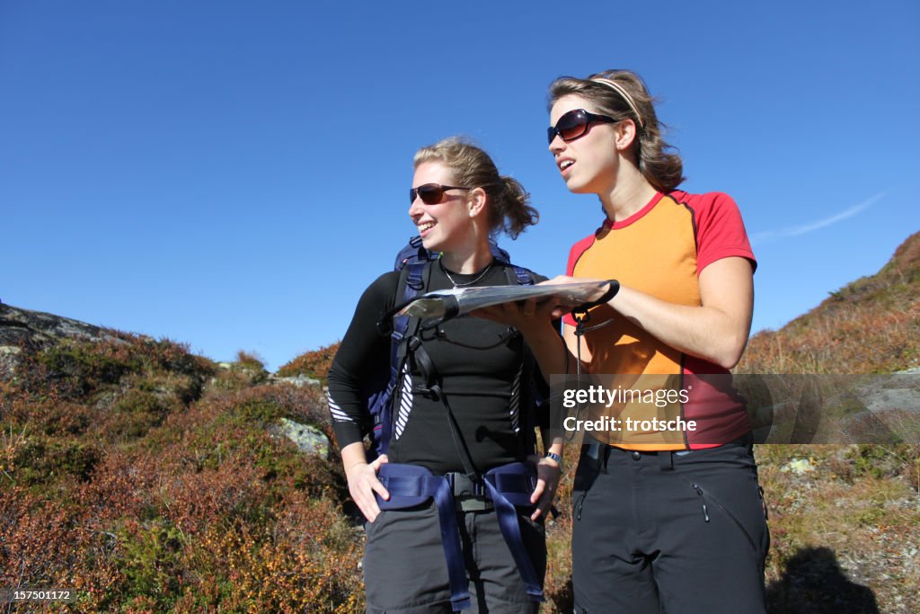 Female hikers reading map