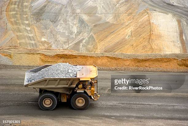 yellow large dump truck in utah copper mine seen from above - mining natural resources stock pictures, royalty-free photos & images