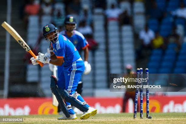 Kuldeep Yadav of India is bowled by Romario Shepherd of West Indies during the first T20I match between West Indies and India at Brian Lara Cricket...