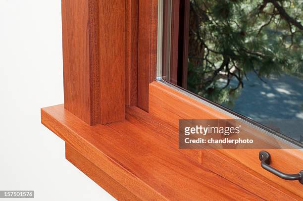 corner of a window sill with a brown wooden frame - window frame stock pictures, royalty-free photos & images