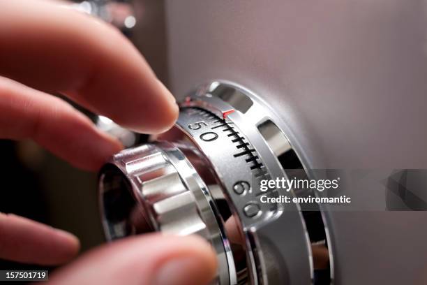 hand opening a safe. - combination lock stock pictures, royalty-free photos & images