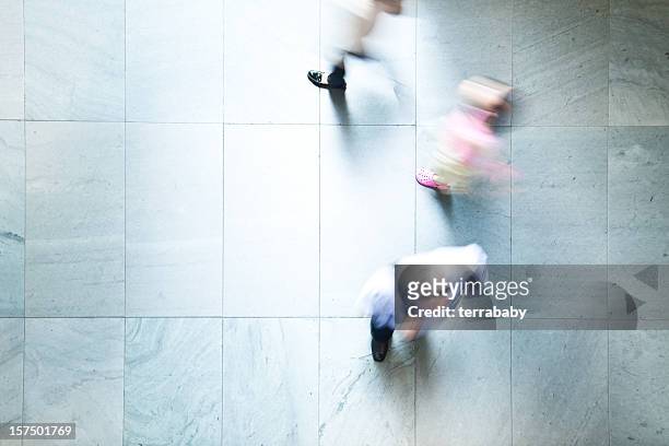 commuters walking by - floor walk business stock pictures, royalty-free photos & images