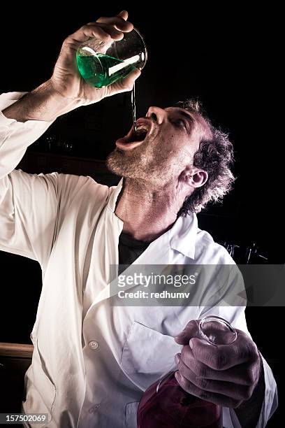mad scientist drinking potion - green potion stock pictures, royalty-free photos & images