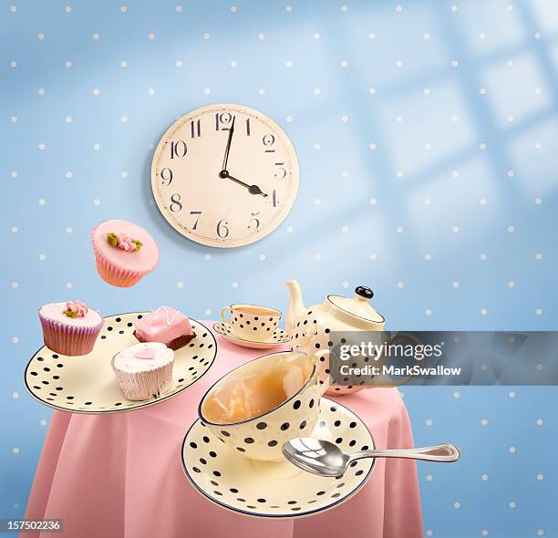 graphics of tea-time with mugs and cakes flying off table - high tea cupcakes stock pictures, royalty-free photos & images