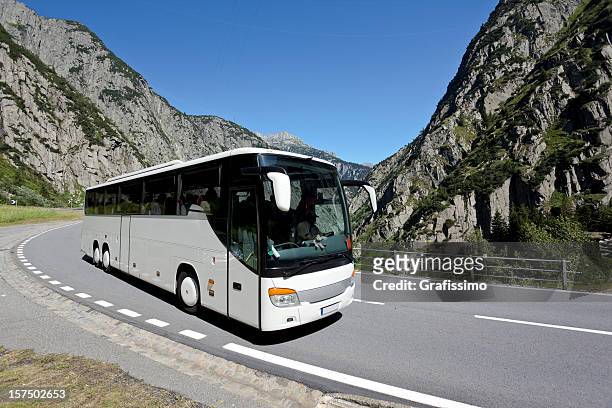 blue sky over white bus crossing the alpes - tourist bus stock pictures, royalty-free photos & images
