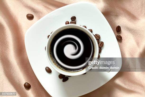 black coffee with cream in china cup, brown satin background - milk swirl stock pictures, royalty-free photos & images