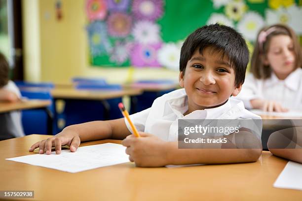 primary school: indian schoolboy happy and carefree in his classroom - schoolboy stock pictures, royalty-free photos & images