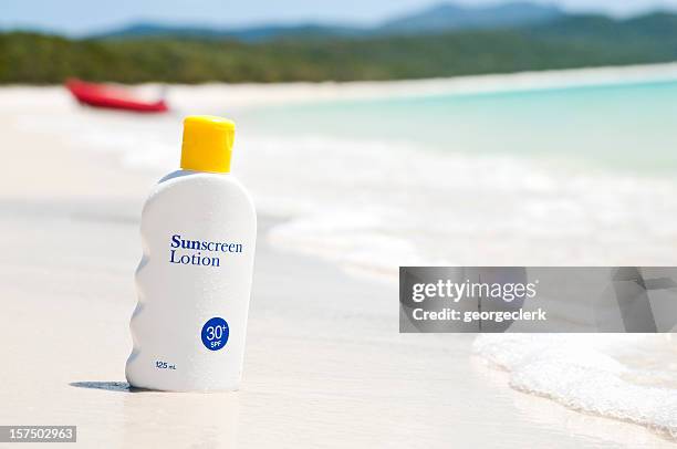 sunscreen lotion on the beach - sun cream stock pictures, royalty-free photos & images