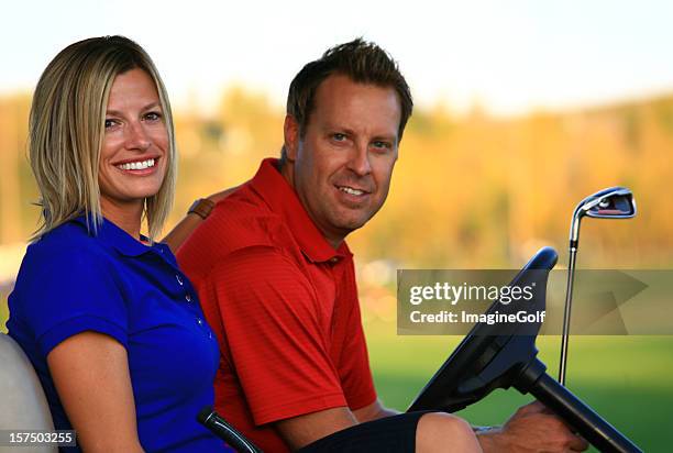 attractive caucasian couple in a golf cart - golf polo stock pictures, royalty-free photos & images