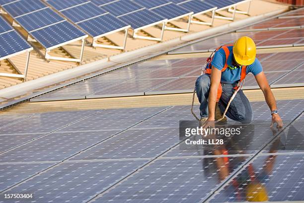supervising a photovoltaic instalation - solar panel installation stock pictures, royalty-free photos & images