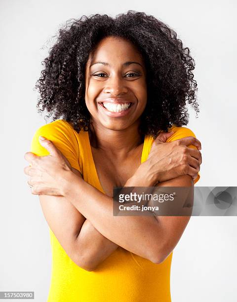 happy young african-american woman hugging herself - krama sig själv bildbanksfoton och bilder