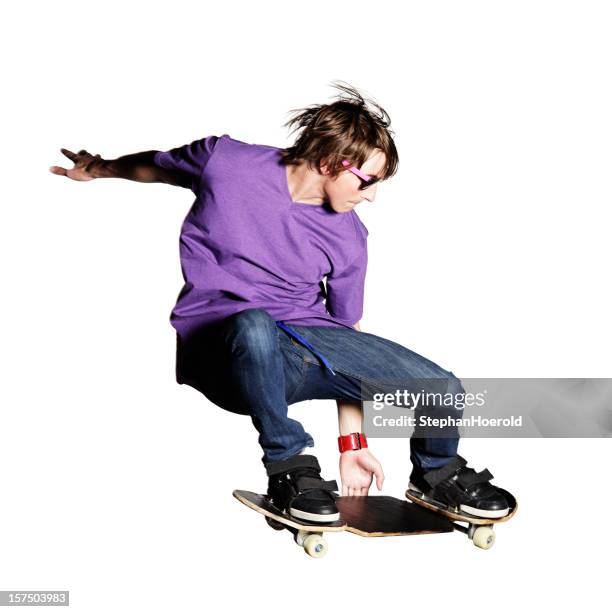 skateboarder in purple shirt and jeans caught mid-air - skater stock pictures, royalty-free photos & images
