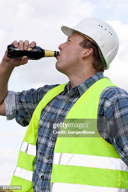 thirsty worker with safety vest - beer helmet stock pictures, royalty-free photos & images