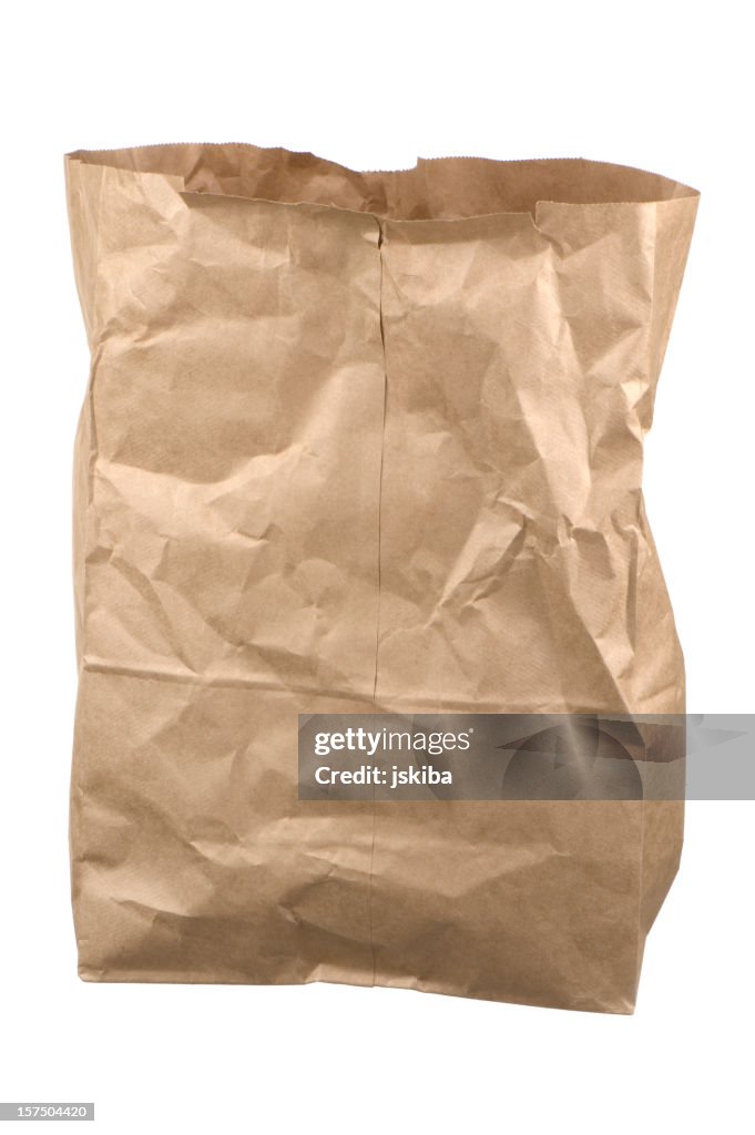 Isolated wrinkled empty brown grocery bag on white background