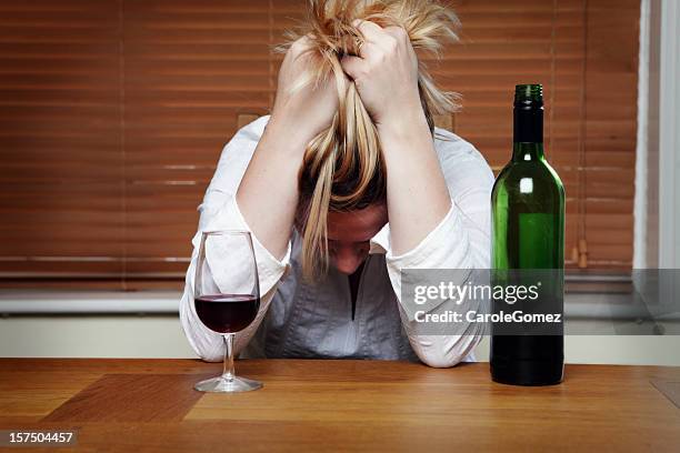 depressed woman with red wine - unhappy woman blonde glasses stock pictures, royalty-free photos & images