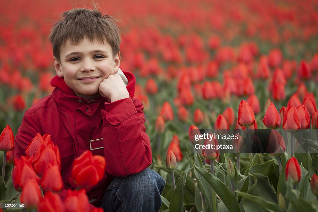Smiling boy in flowers