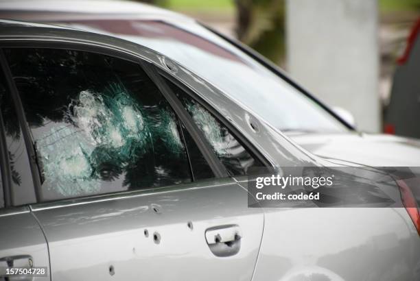 armoured car with bullet holes, crime and terrorism concept - bullet holes stockfoto's en -beelden