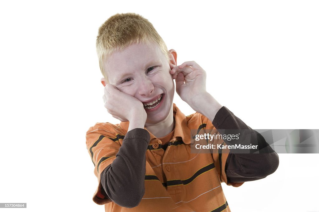 A boy with autism smiling at the camera