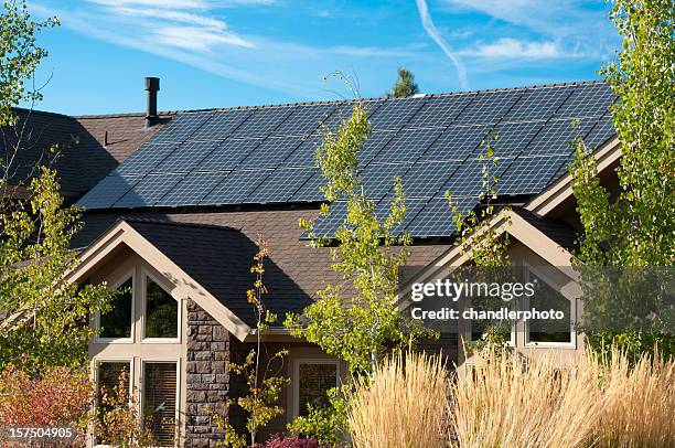 solar panels on the roof of a house - panel solar stock pictures, royalty-free photos & images