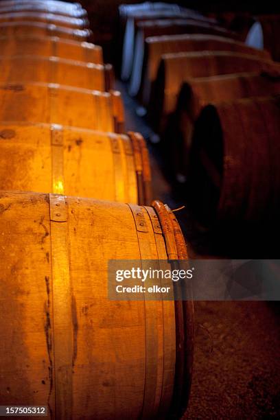whiskey casks in a scotch distillery. - scotland distillery stock pictures, royalty-free photos & images