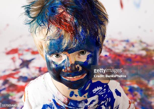 boy covered with paint - faces aftermath of storm eleanor stockfoto's en -beelden