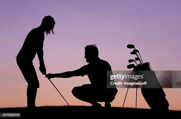 silhouette of woman recieving golf lesson from instructor - driving range 個照片及圖片檔