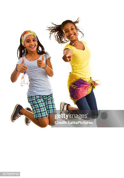 two teenage girls jumping mid-air with thumbs up - jumping girl stock pictures, royalty-free photos & images