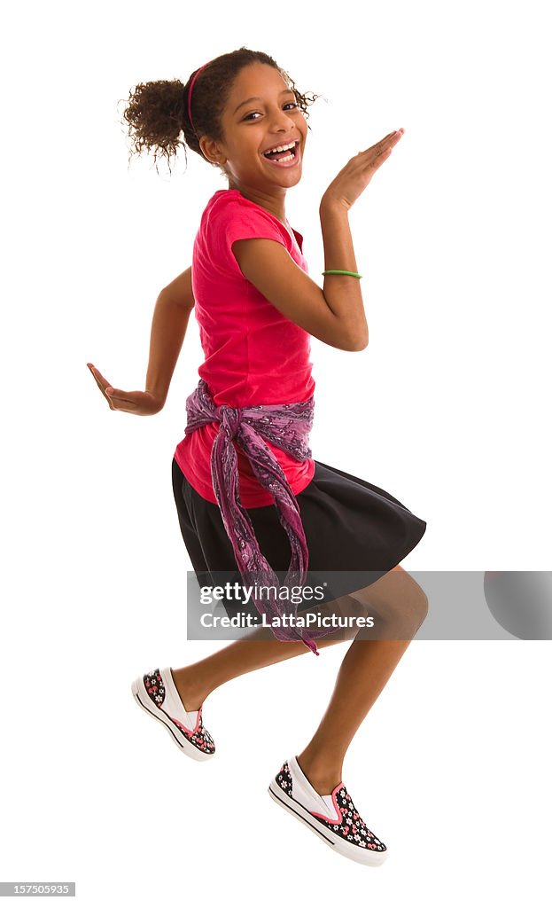 Elementary age girl jumping in air and smiling