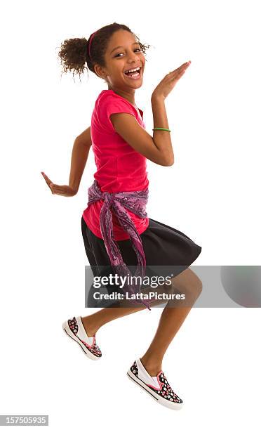 elementary age girl jumping in air and smiling - freestyle dance stock pictures, royalty-free photos & images