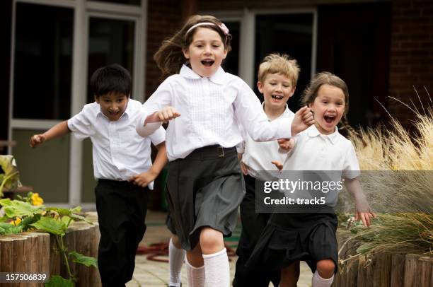 primary school: junior school children running out of their school - playing tag stock pictures, royalty-free photos & images
