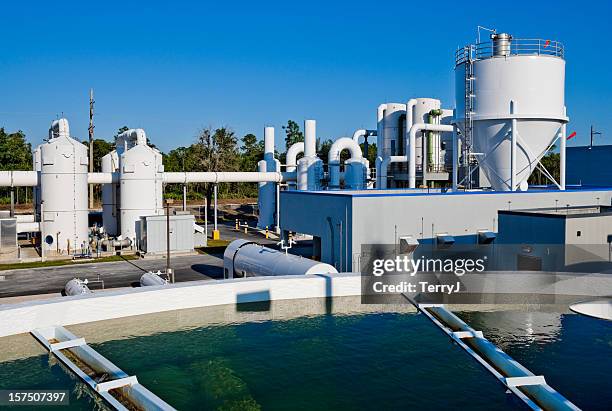 water treatment facility with water tank in foreground - aquatic plant stock pictures, royalty-free photos & images