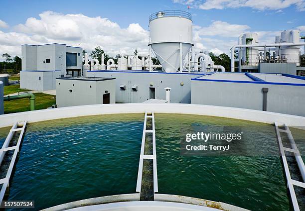 overlooking a water tank at water treatment plant - water plant stock pictures, royalty-free photos & images