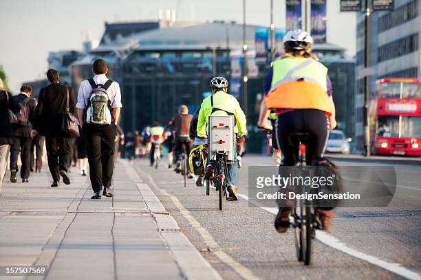 commuters on foot and cycling - riding stock pictures, royalty-free photos & images