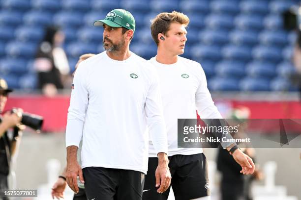 Aaron Rodgers and Zach Wilson of the New York Jets warm up prior to the 2023 Pro Hall of Fame Game against the Cleveland Browns at Tom Benson Hall Of...