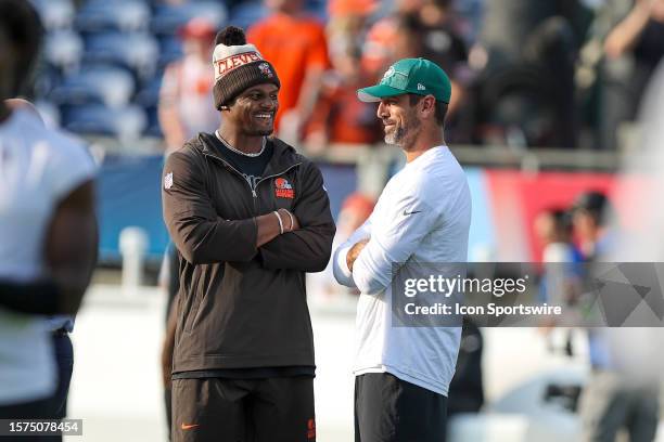 Cleveland Browns quarterback Deshaun Watson and New York Jets quarterback Aaron Rodgers meet at midfield prior to the National Football League Hall...