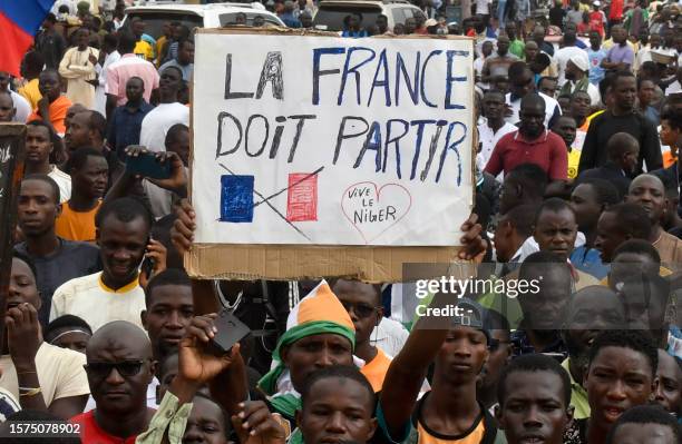 Protesters hold an anti-France placard during a demonstration on independence day in Niamey on August 3, 2023. Niger's junta on August 3 said it was...