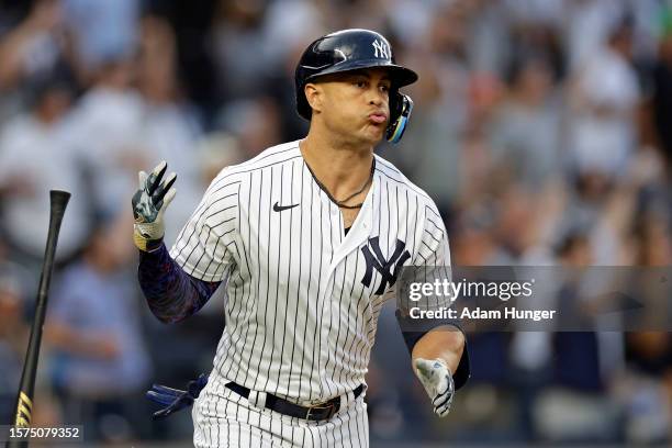 Giancarlo Stanton of the New York Yankees reacts after hitting a home run against the Houston Astros during the first inning at Yankee Stadium on...